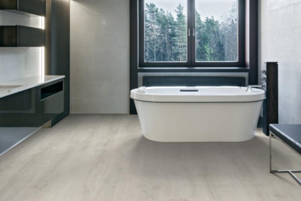 wood-look laminate flooring in bathroom with bathtub.